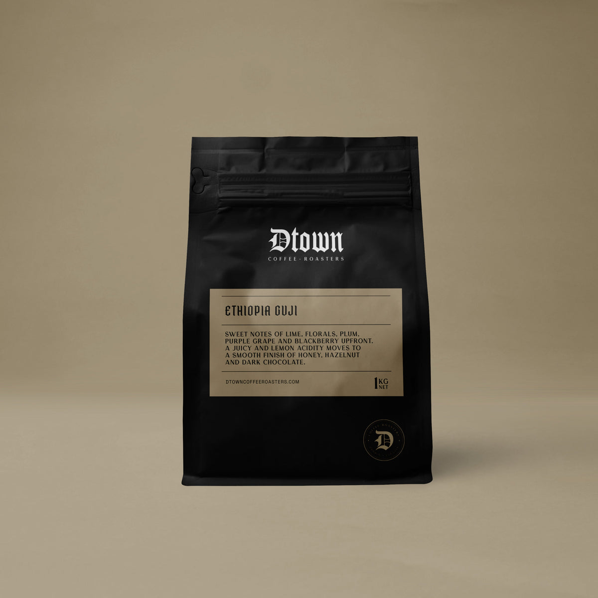 Black coffee bag with 'Dlown Coffee Roasters' branding on a beige background